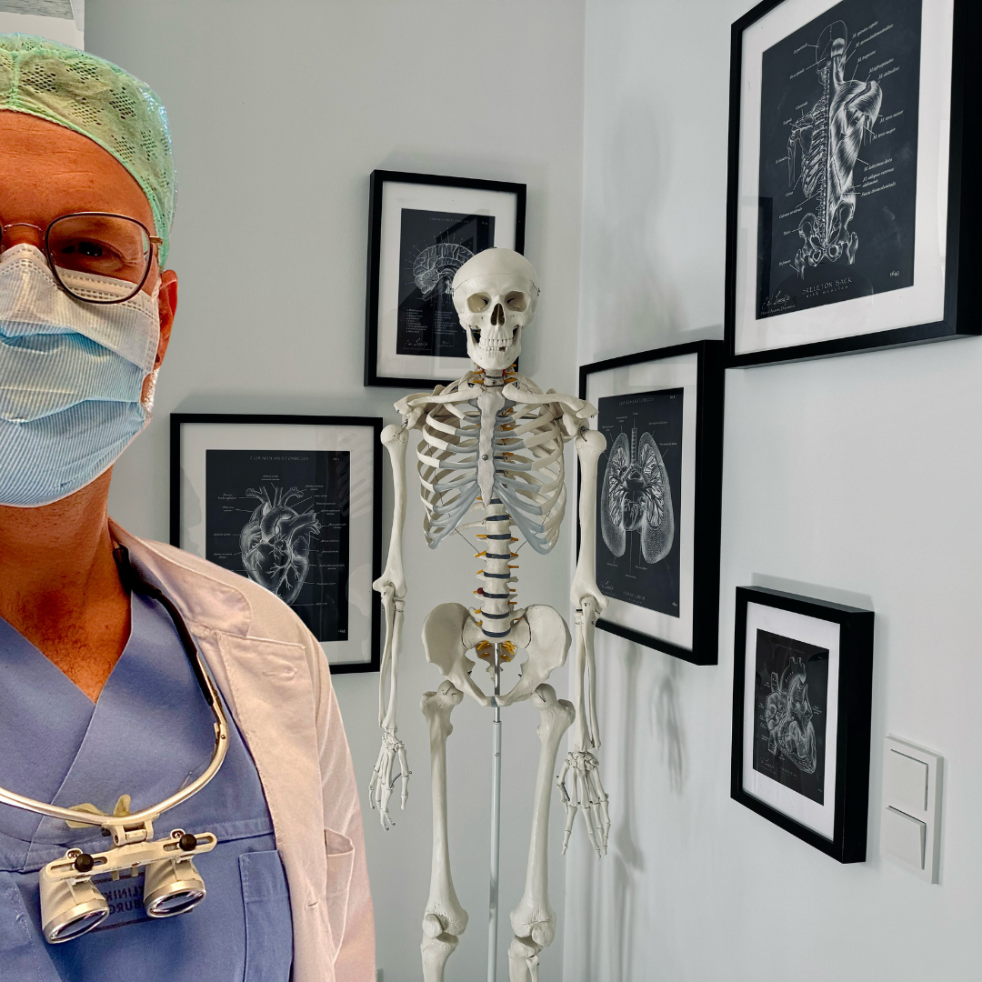 Practitioner with skeleton model and anatomical drawings used for patient education
